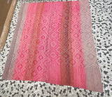 Archival Textile No. 112 vintage Peruvian Frazada rug laid flat showing intricate nested diamond pattern with alternating fuchsia and rose vertical color bands with terracotta and grey edges