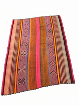 Archival Textile No. 106: A large vintage Peruvian Frazada rug featuring a high-contrast electric fuchsia center field and traditional indigo and earth-tone symbols. This one-of-a-kind hand-loomed wool rug is showcased on a white background, highlighting its symmetrical iconography and signature central union seam."
