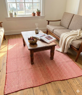 Archival Textile No. 110 vintage Peruvian Frazada rug styled in modern living room with mid-century sofa showing micro-diamond weave in dusty rose and peach as functional statement area rug