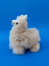 Front view of a 7 inch small natural white alpaca llama made from undyed Huacaya fur.