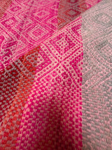 Detail of Frazada No. 112 showing dense hand-loomed diamond eye weave in fuchsia and rose gradient typical of Cusco highlands backstrap loom tradition