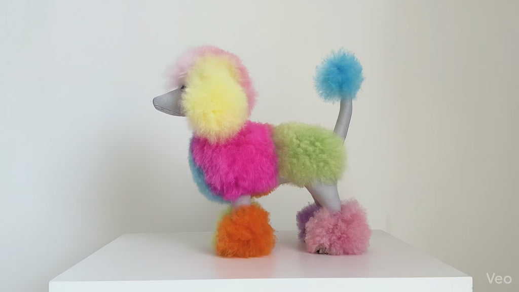 3D animated lifestyle video of the Inspired Peru limited-edition 12-inch rainbow alpaca fur poodle plush moving dynamically against a minimal neutral background to showcase its vibrant pastel color pattern and fluffy texture