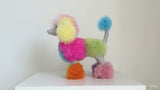 3D animated lifestyle video of the Inspired Peru limited-edition 12-inch rainbow alpaca fur poodle plush moving dynamically against a minimal neutral background to showcase its vibrant pastel color pattern and fluffy texture