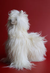 Side view of 12 inch silky white Suri alpaca stuffed animal with long shimmering fur