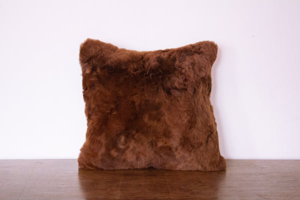 alpaca fur pillow on dark brown color